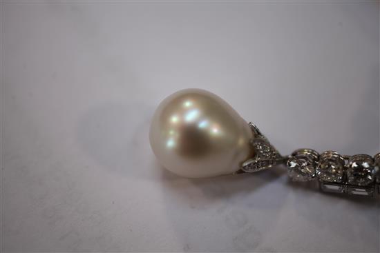 An attractive pair of late 20th century platinum, diamond and baroque pearl drop metamorphic earrings, overall 62mm.